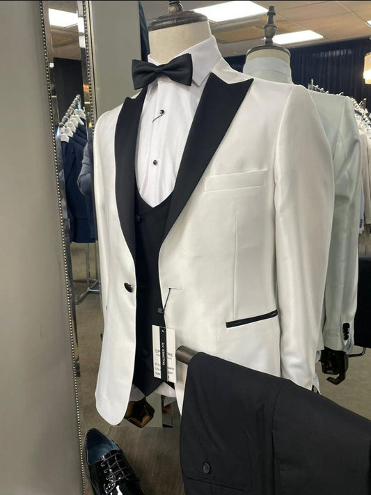 White tuxedo jacket with black vest and bow tie on a mannequin in a store setting.