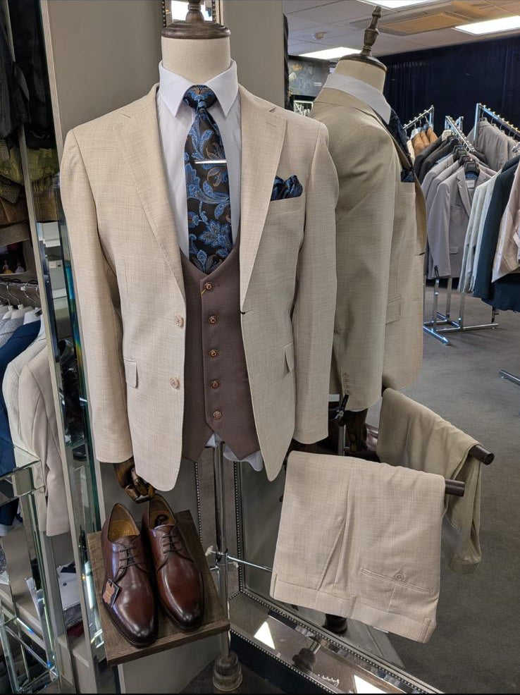 Beige suit with vest and tie on a mannequin in a store setting