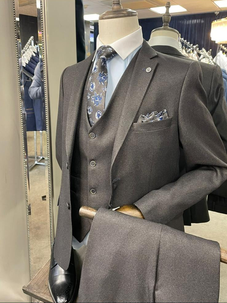 Gray suit on a mannequin with a patterned tie in a store setting