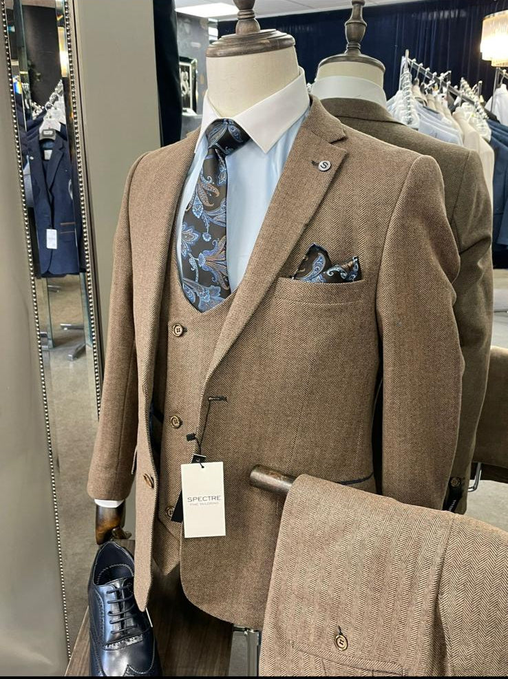 Brown suit on a mannequin with a tie and pocket square in a store setting